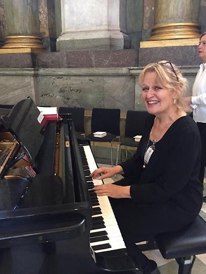  Marianne Ivarsson sitter vid ett piano.