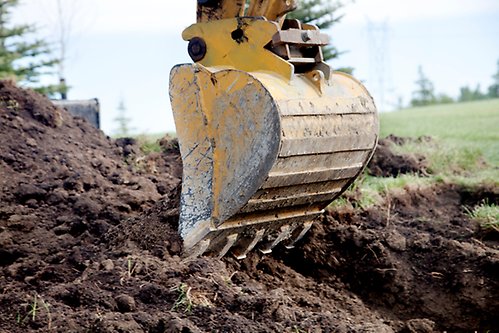 Bild på grävmaskin som gräver